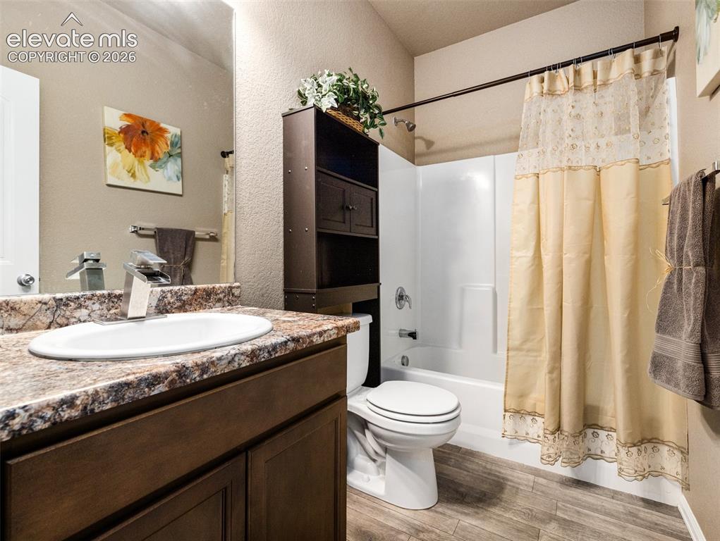 Image 19 of 24: Spa-inspired bathroom featuring a dark wood vanity with a granite-topped co