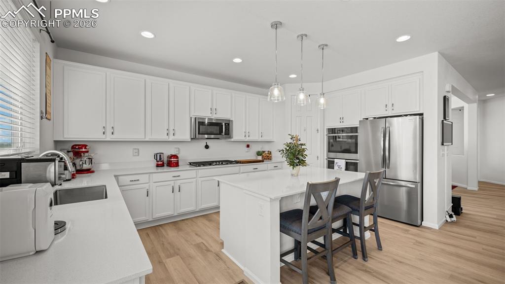 Image 3 of 46: Gourmet kitchen with quartz island, double ovens, gas range, large pantry, 