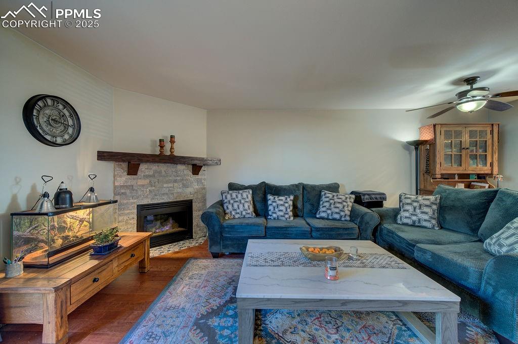 Image 16 of 37: The Living Room has a gas fireplace with stone surround to cozy up on chill