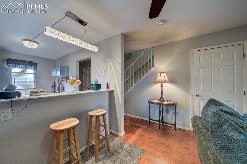 Image 19 of 37: Dining Area and Kitchen with stairs to the upper level.