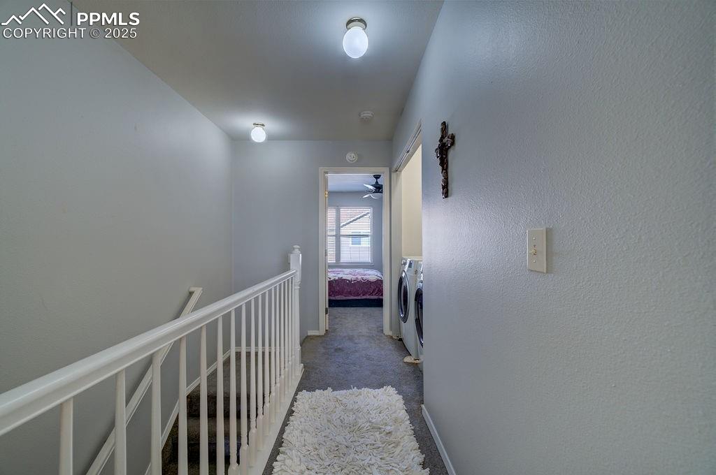Image 20 of 37: Upepr level hallway with laundry closet.
