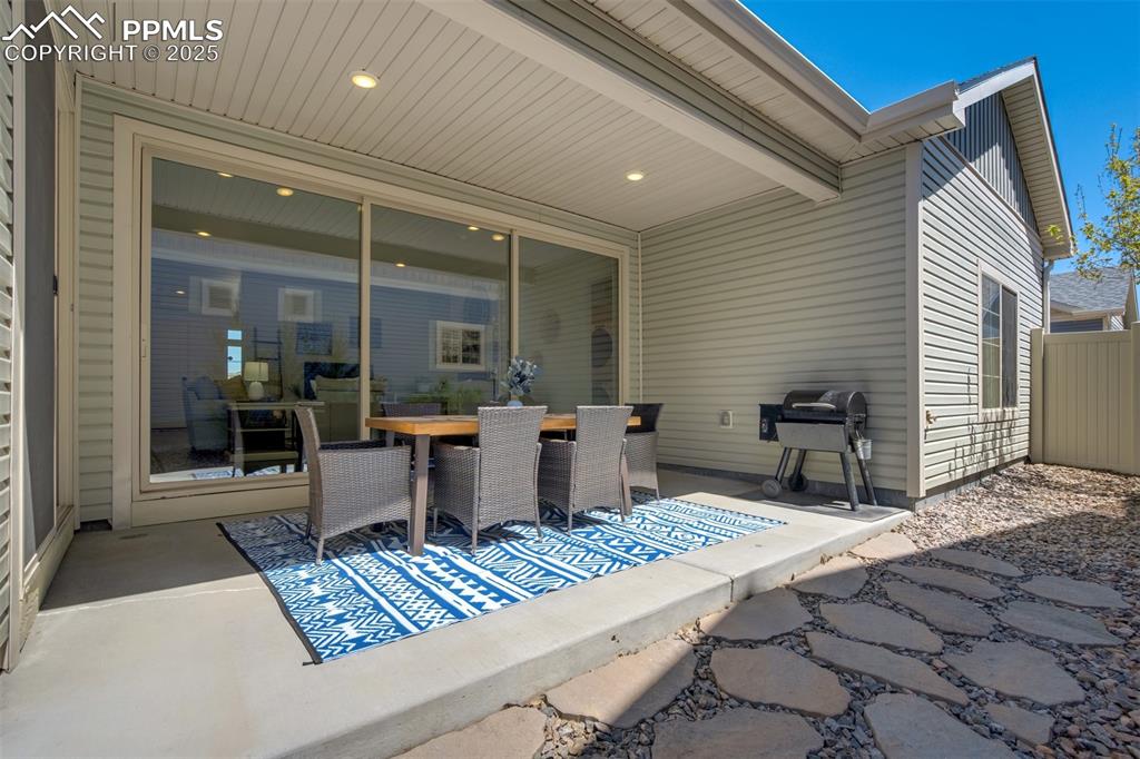 Image 44 of 46: Covered patio with private yard.