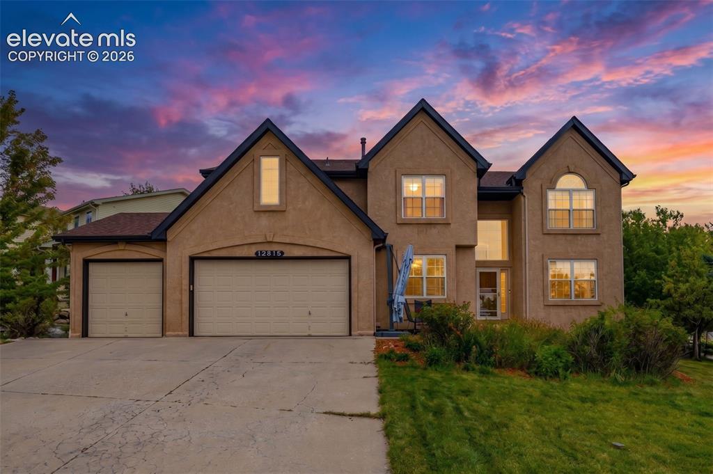 Image 1 of 50: Stucco exterior with multiple gables and a two-story entryway