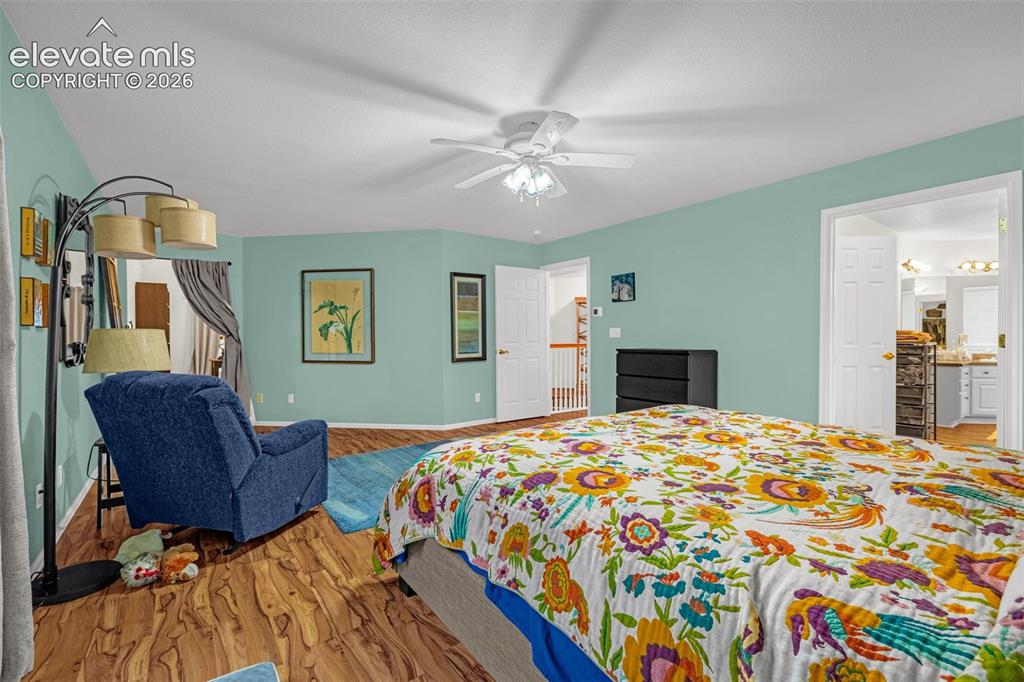 Image 18 of 50: Wood-finish flooring throughout, ceiling fan with integrated lighting, and 