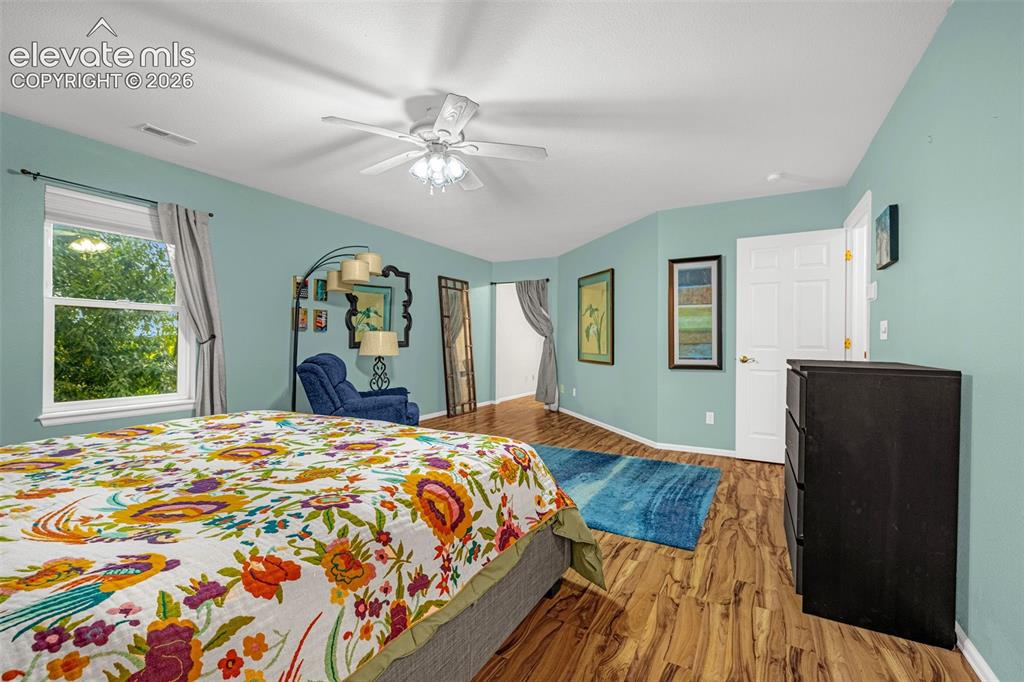 Image 19 of 50: Wood-finish flooring throughout, white trim, and a ceiling fan with integra