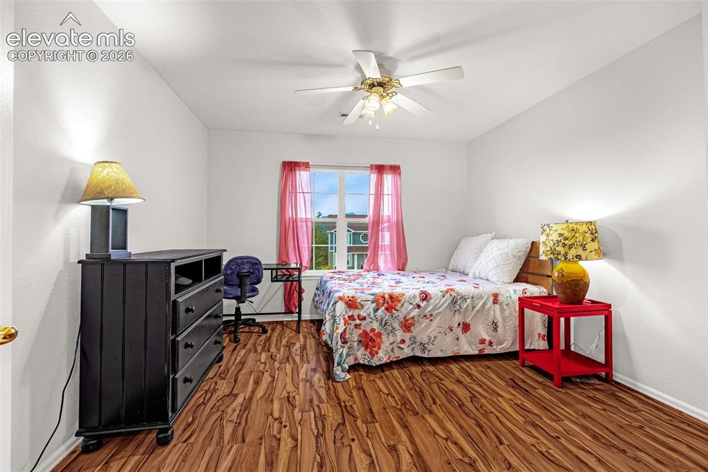 Image 25 of 50: Wood-finish flooring, ceiling fan with integrated lighting, white painted w