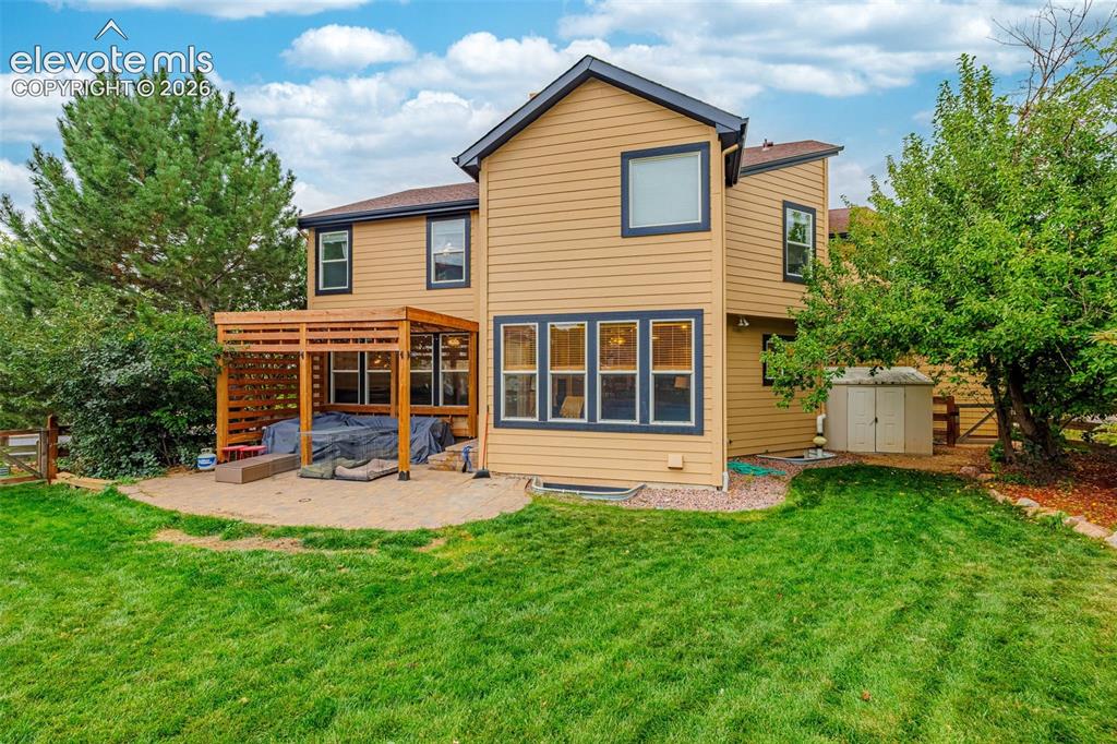 Image 36 of 50: Expansive backyard featuring a manicured lawn, established perimeter trees,