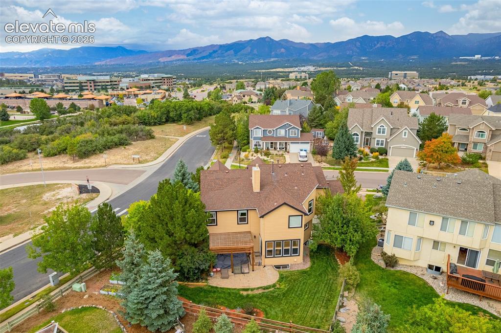 Image 45 of 50: Expansive mountain backdrop, residential neighborhood setting, mature lands