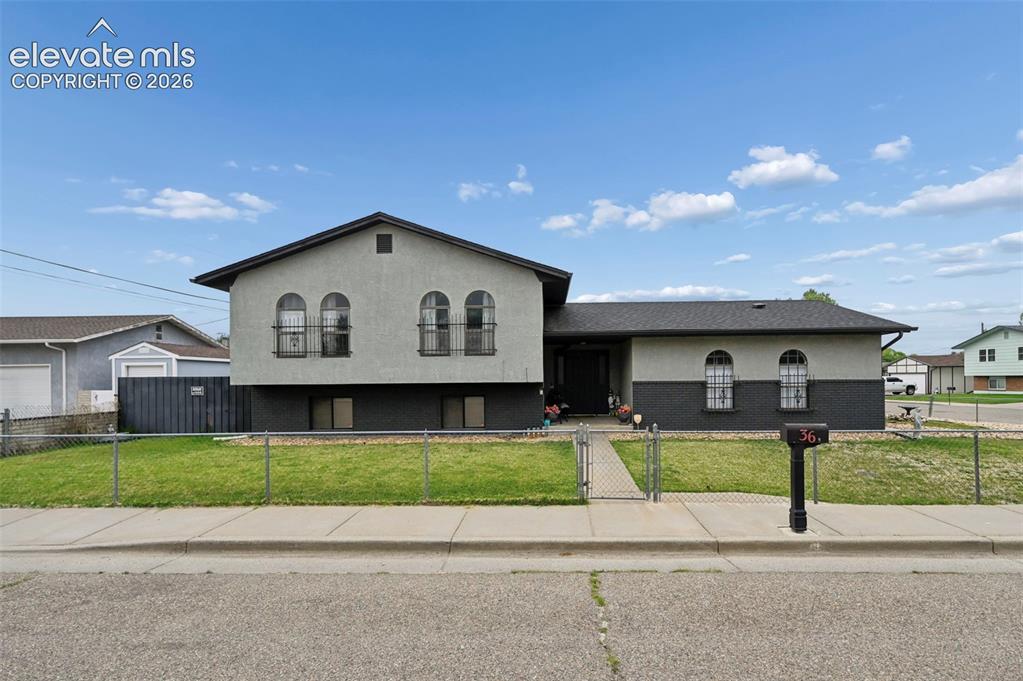 Image 1 of 20: Stucco exterior with an asphalt shingle roof