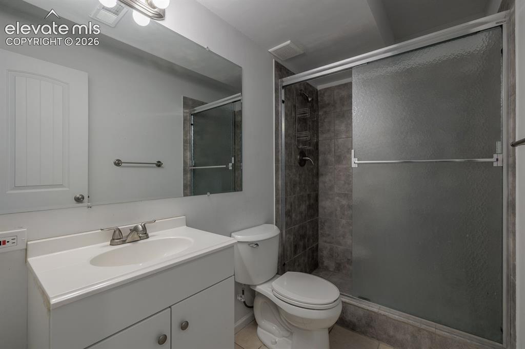 Image 10 of 36: Bathroom featuring a white vanity with integrated sink, brushed nickel fauc