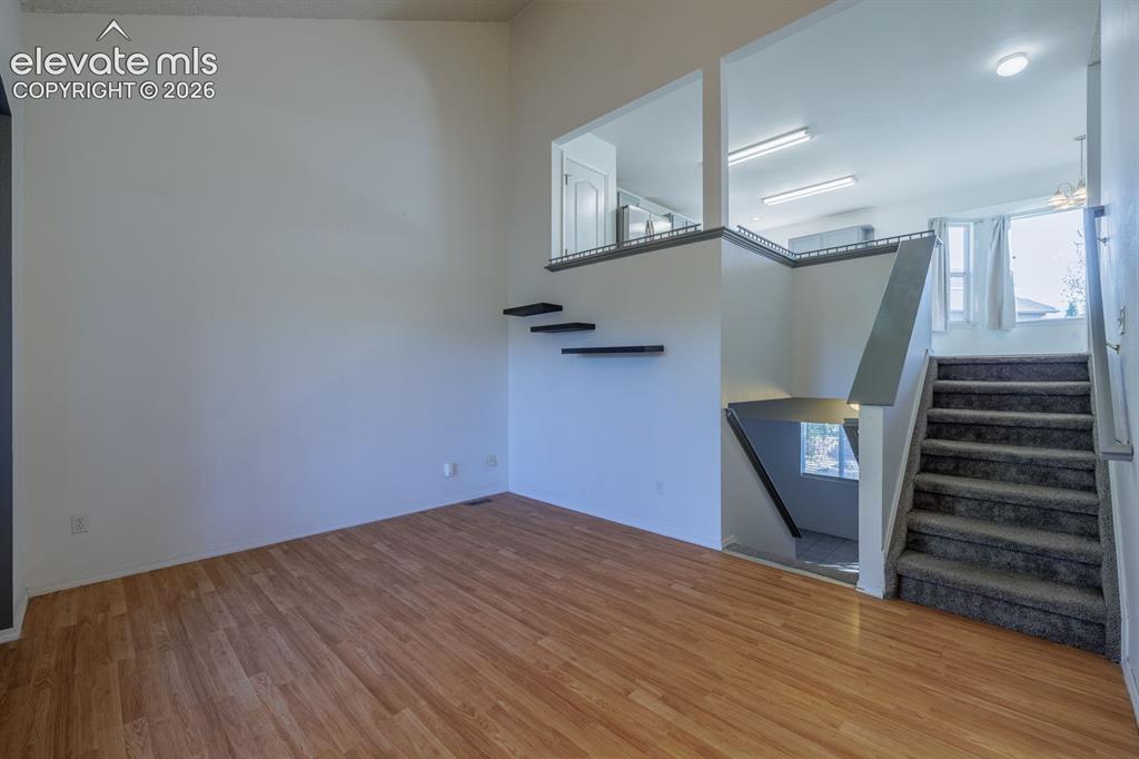 Image 4 of 36: Wood-finish flooring, high ceilings, and a multi-level design