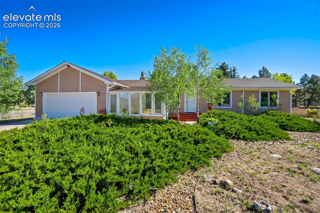 Image 1 of 45: Single-story residence featuring a stucco exterior, attached garage, and a