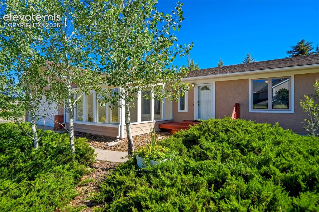Image 3 of 45: Exterior featuring a stucco finish, a covered entry with a red-painted deck