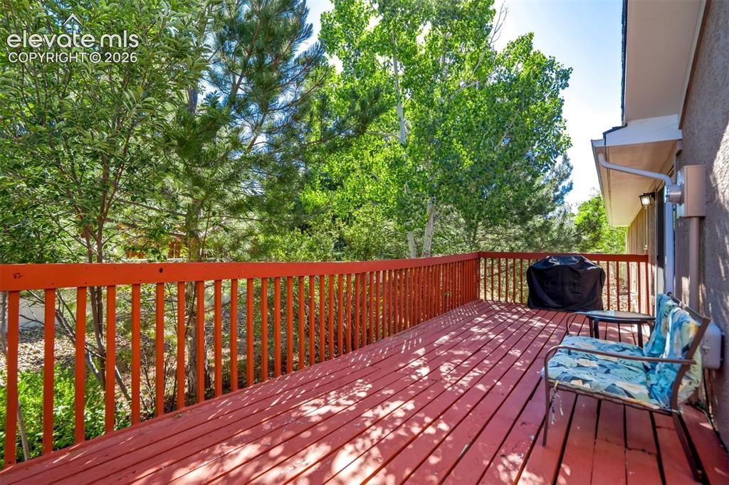 Image 38 of 45: Spacious wood deck with a red finish, offering an outdoor living area