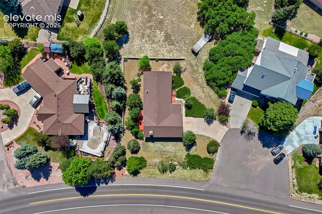 Image 43 of 45: Aerial perspective showcasing a property featuring a brown shingle roof and