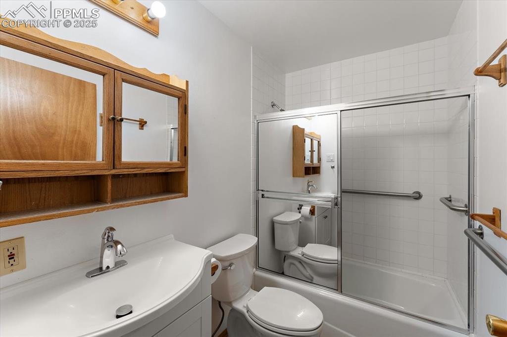 Image 18 of 44: Full bathroom featuring enclosed tub / shower combo and vanity