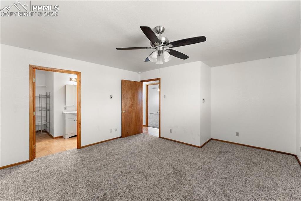 Image 22 of 44: Unfurnished bedroom featuring carpet flooring, ensuite bathroom, and a ceil