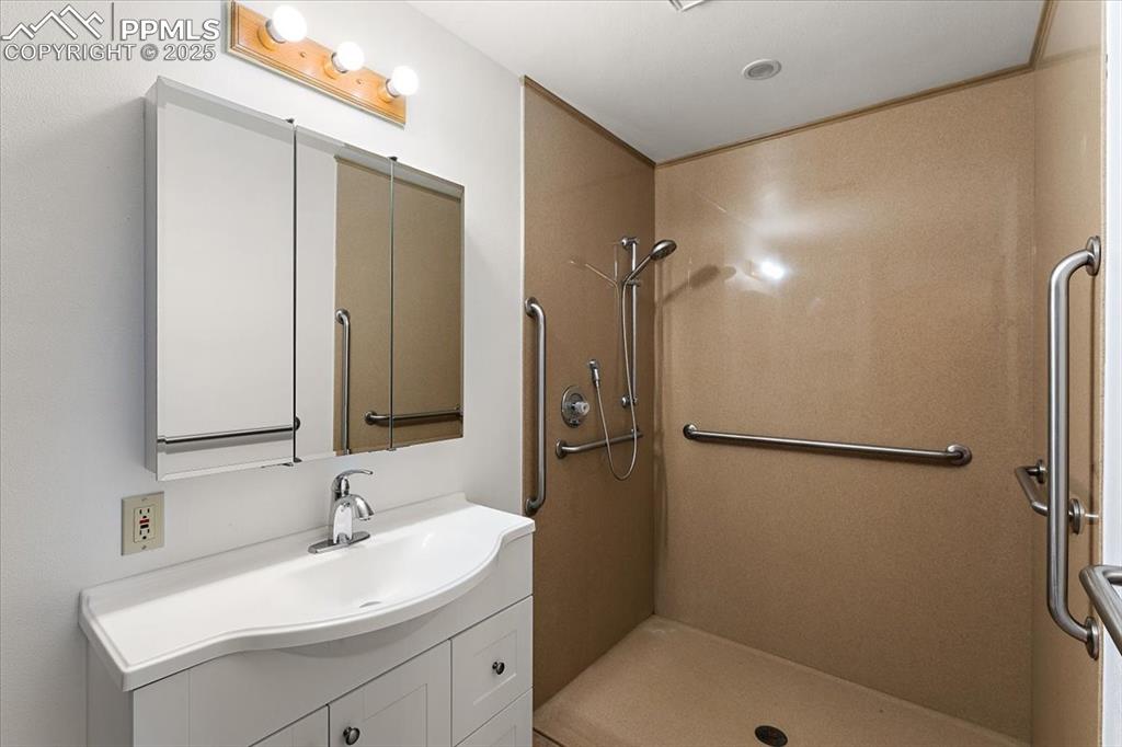 Image 23 of 44: Full bath featuring vanity and a shower stall