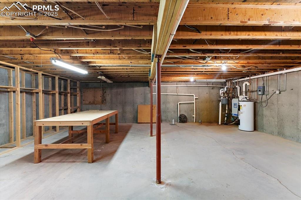 Image 31 of 44: Unfinished basement featuring electric water heater