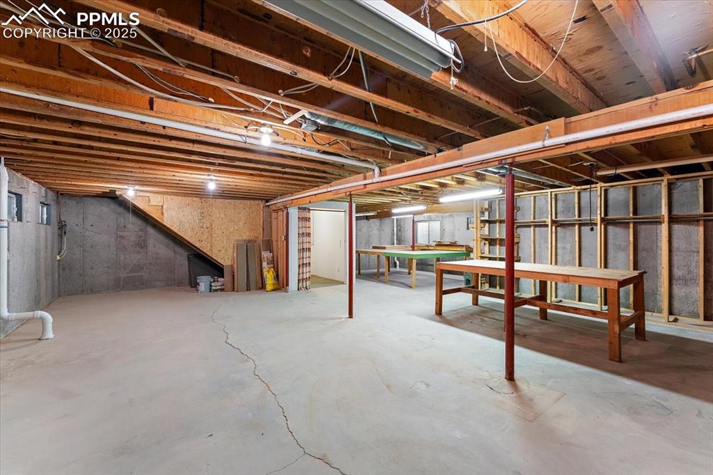 Image 32 of 44: Unfinished below grade area featuring pool table