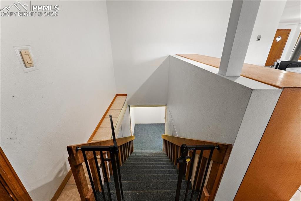 Image 9 of 44: Stairway featuring a textured wall and carpet