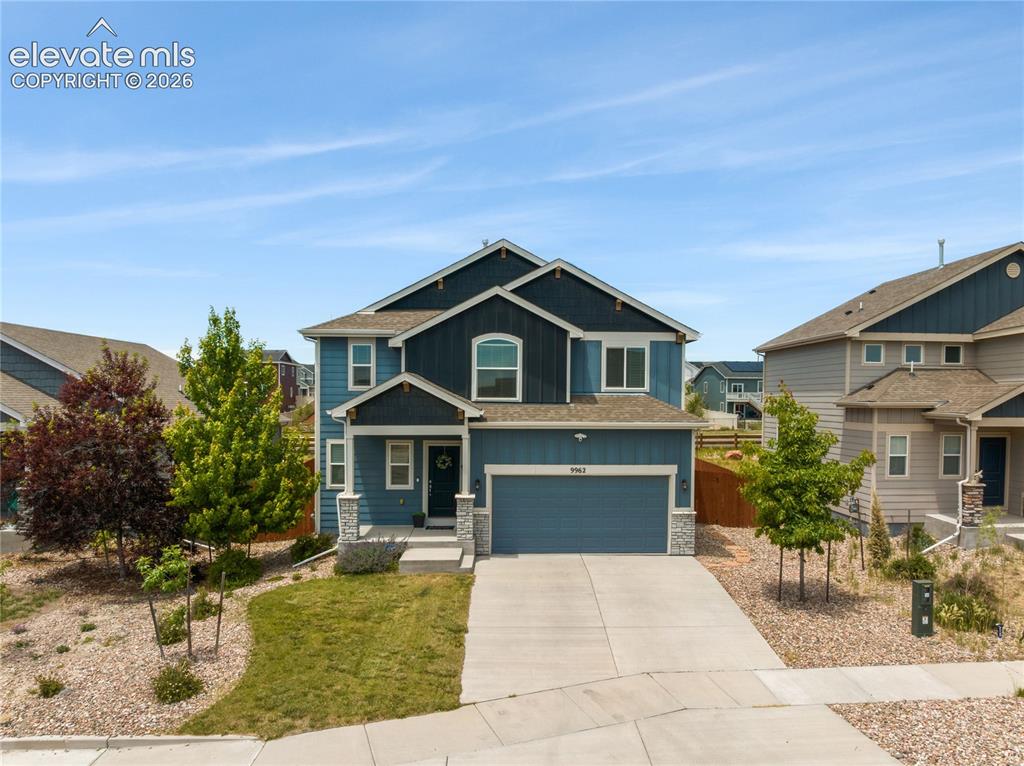 Image 1 of 50: Two-story residential structure featuring a two-car garage, stone accents,