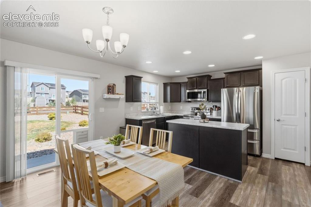Image 11 of 50: Open concept kitchen and dining area with LVP flooring