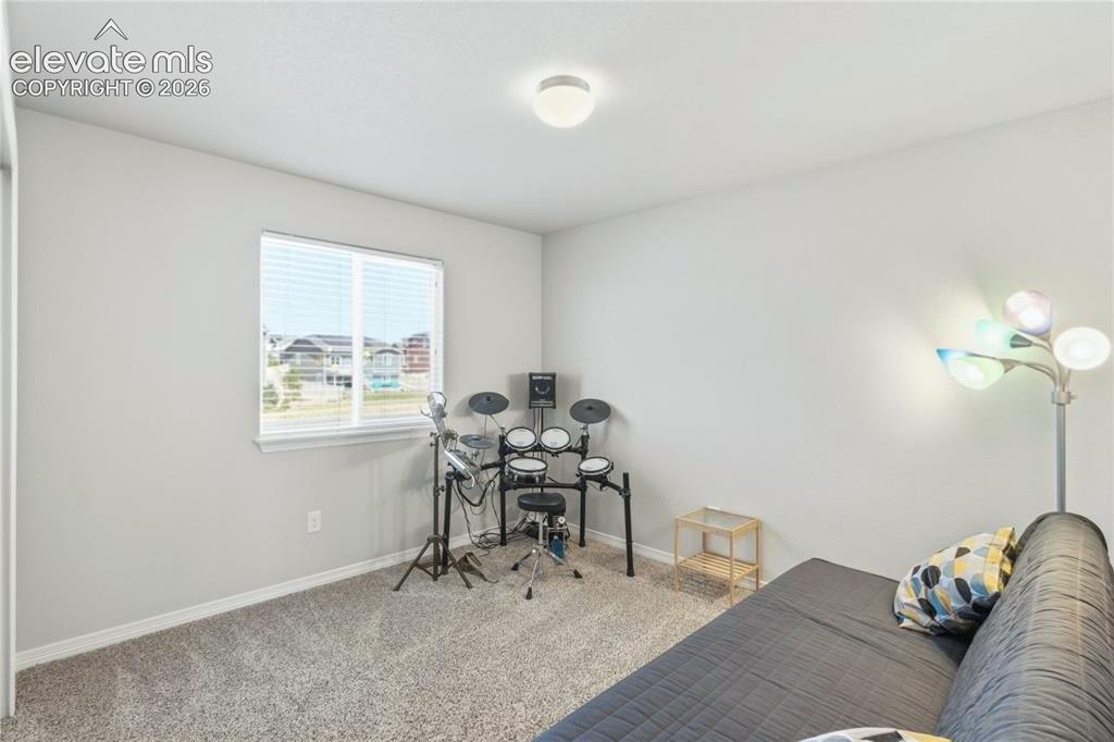 Image 16 of 50: Carpeted room featuring light gray walls, a window with horizontal blinds,