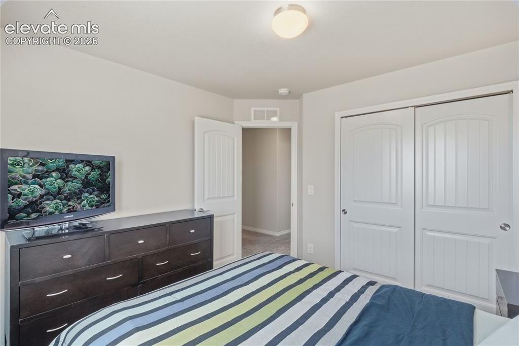 Image 22 of 50: Bedroom featuring light gray walls, white ceiling, and carpet flooring