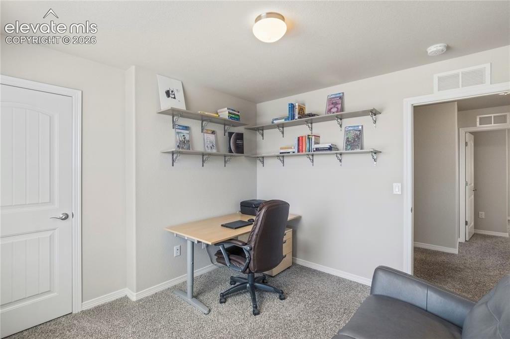 Image 24 of 50: Flexible space featuring grey carpet flooring and light-toned walls