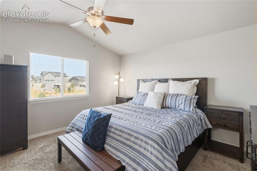 Image 26 of 50: Spacious room featuring vaulted ceilings, a large window, neutral wall pain
