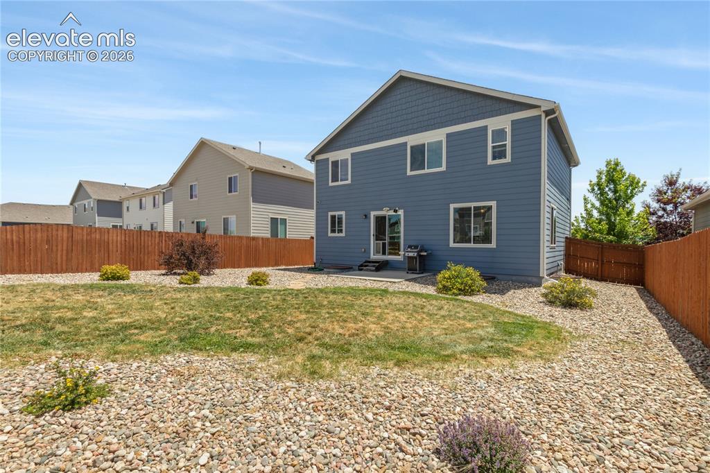 Image 35 of 50: Blue siding exterior with shingle accent detailing, featuring a concrete pa