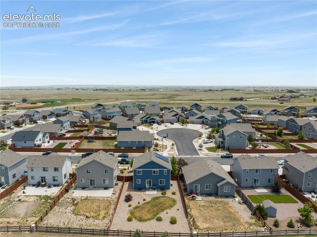 Image 42 of 50: Aerial view of a residential development featuring single-family homes with