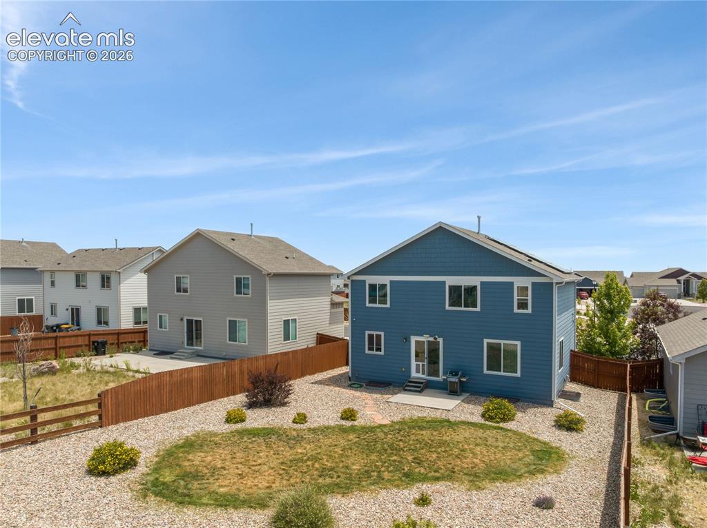 Image 45 of 50: Two-story residence featuring blue siding and white trim