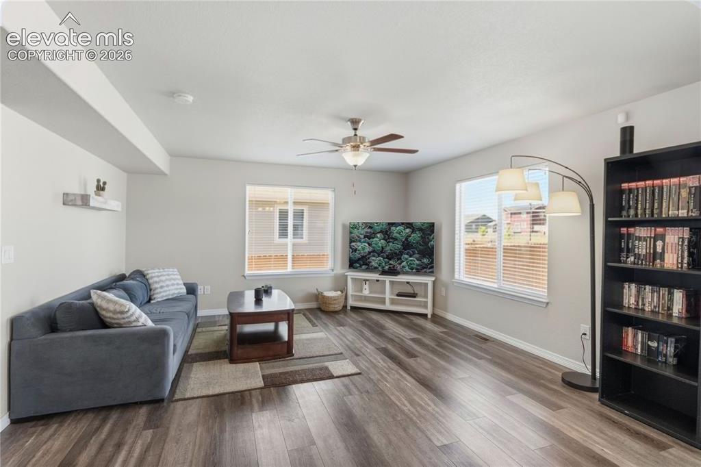 Image 5 of 50: Spacious living area featuring LVP flooring, and multiple windows with blin
