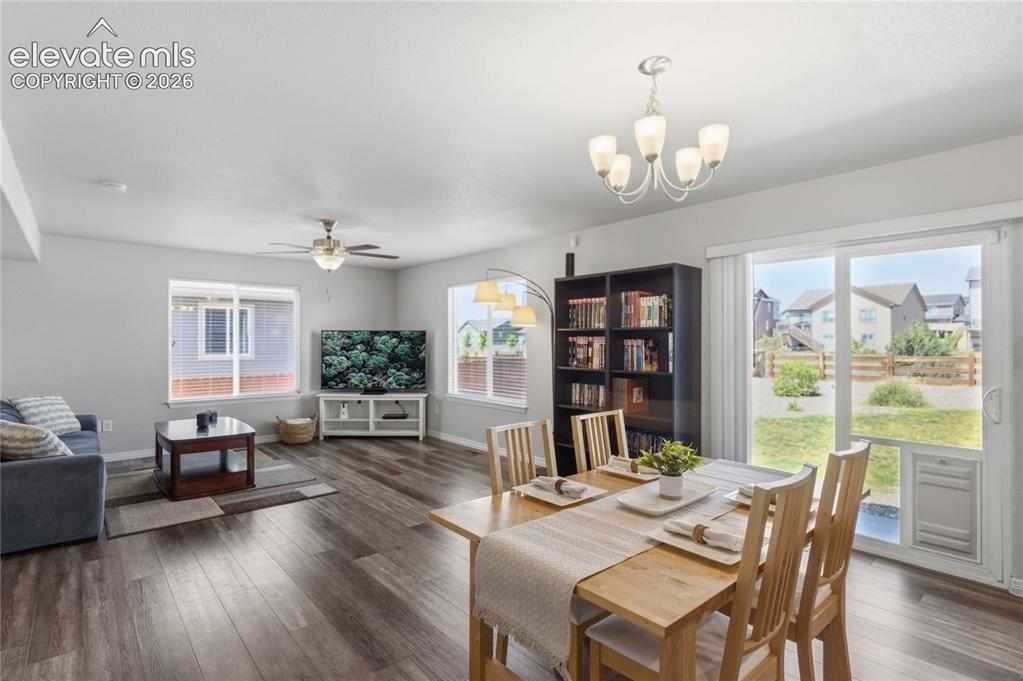 Image 8 of 50: Open-concept living area with LVP flooring, recessed lighting, and light gr