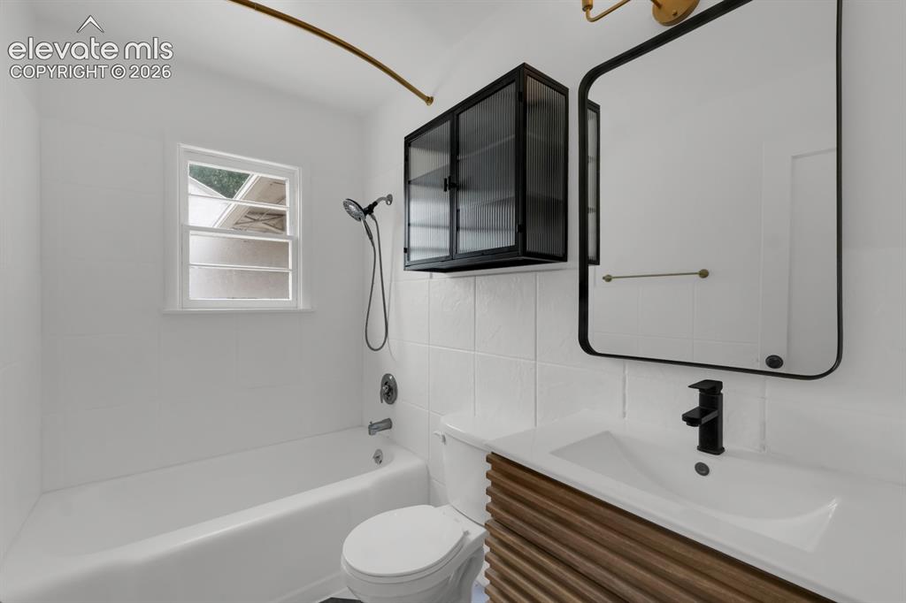 Image 4 of 23: Main-level full bathroom with custom vanity and new fixtures.