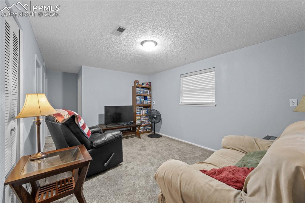 Image 12 of 21: Extra living area, great for media, gym, or family hangout.