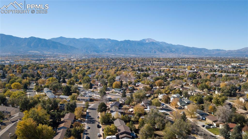 Image 12 of 15: Aerial perspective of suburban area with a mountain backdrop