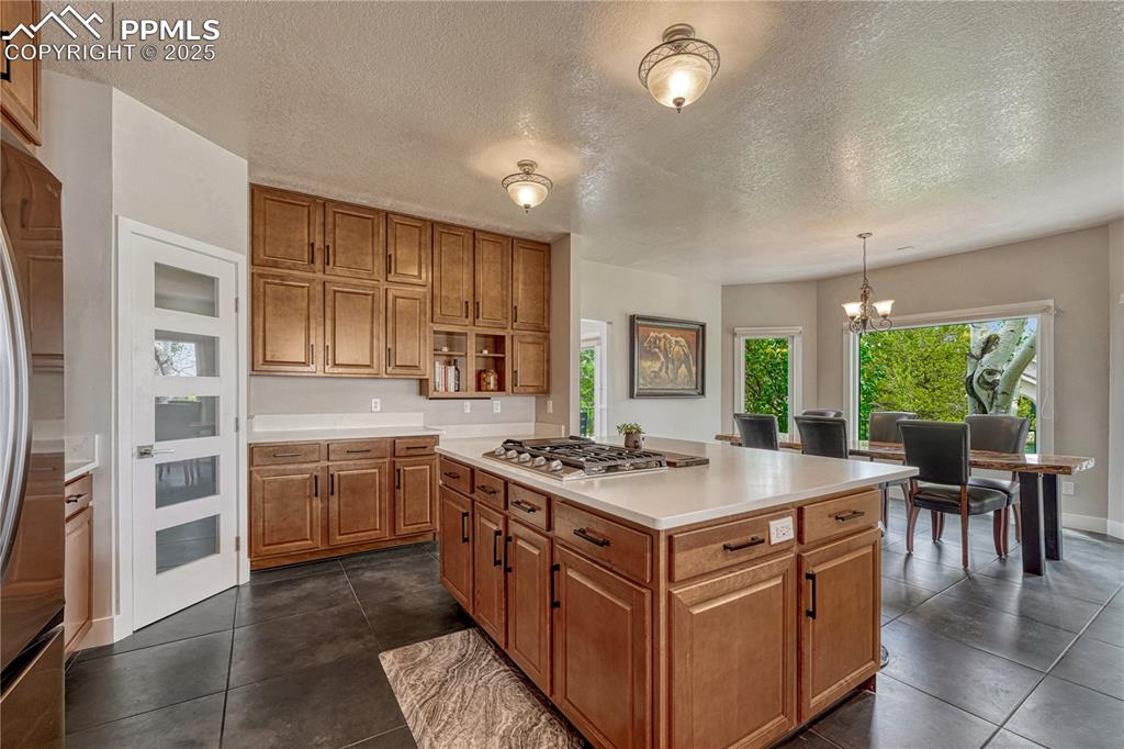 Image 34 of 47: Kitchen with appliances with stainless steel finishes, light countertops, b
