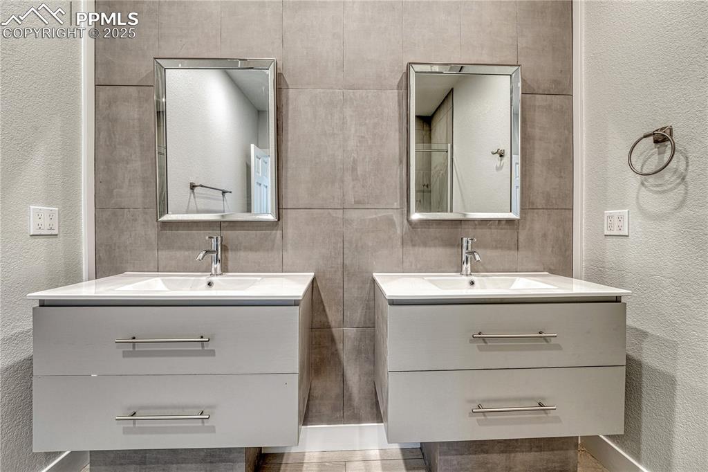 Image 40 of 47: Bathroom featuring vanity and a textured wall