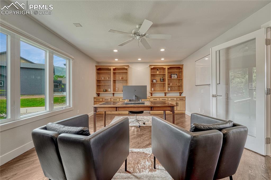 Image 6 of 47: Office space with a ceiling fan, light wood-style flooring, and recessed li