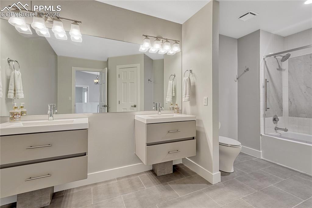 Image 9 of 47: Full bath in upper hallway featuring tile patterned flooring, vanity, and w