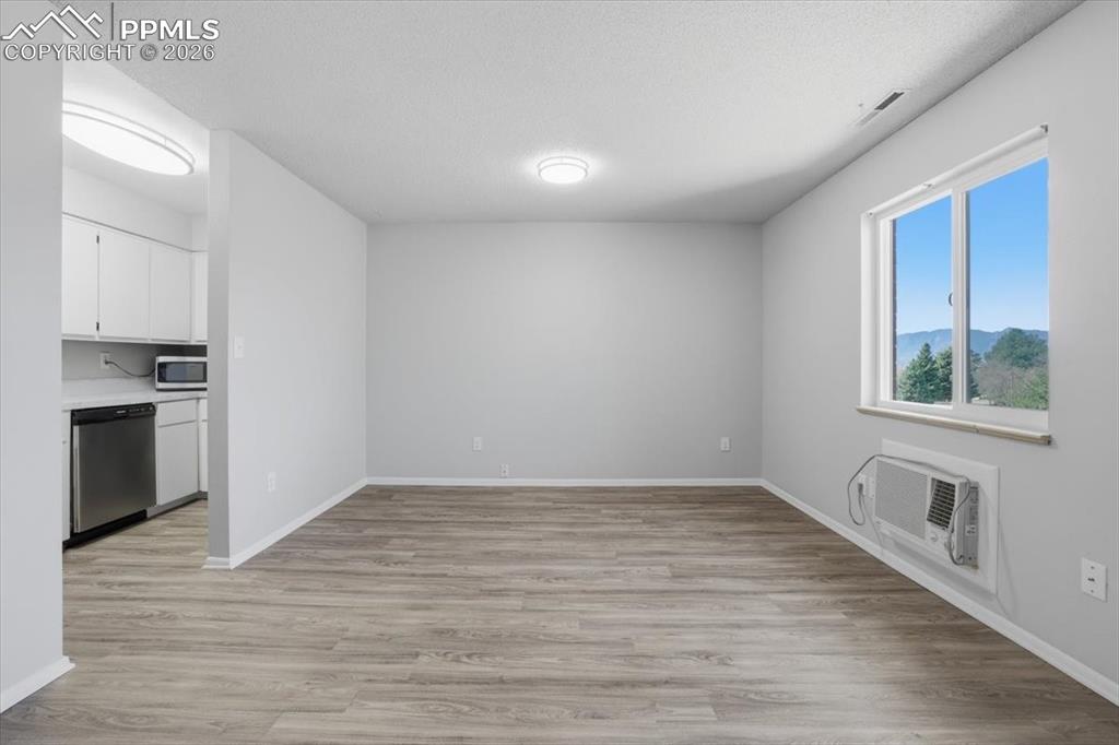 Image 11 of 34: Living room with AC unit.