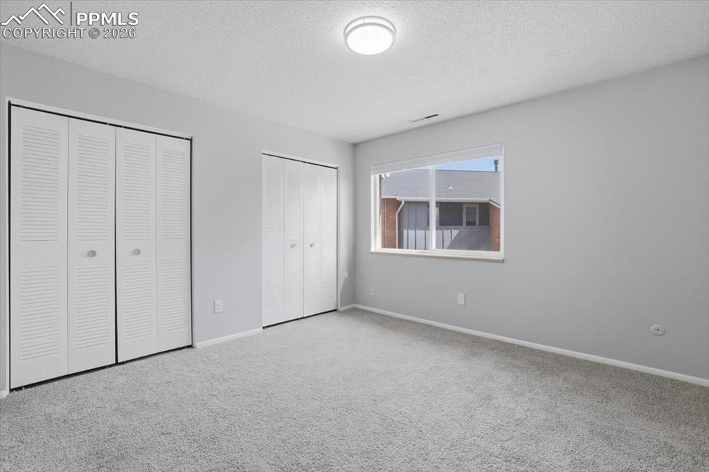 Image 18 of 34: Large bedroom with dual closets.