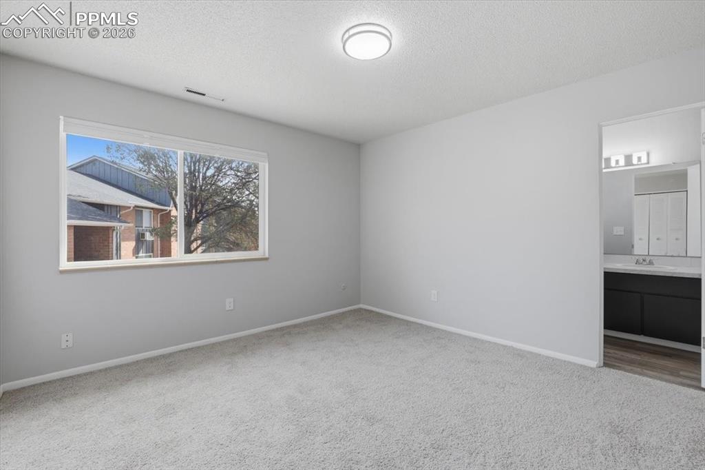 Image 4 of 34: Bedroom with attached bathroom.