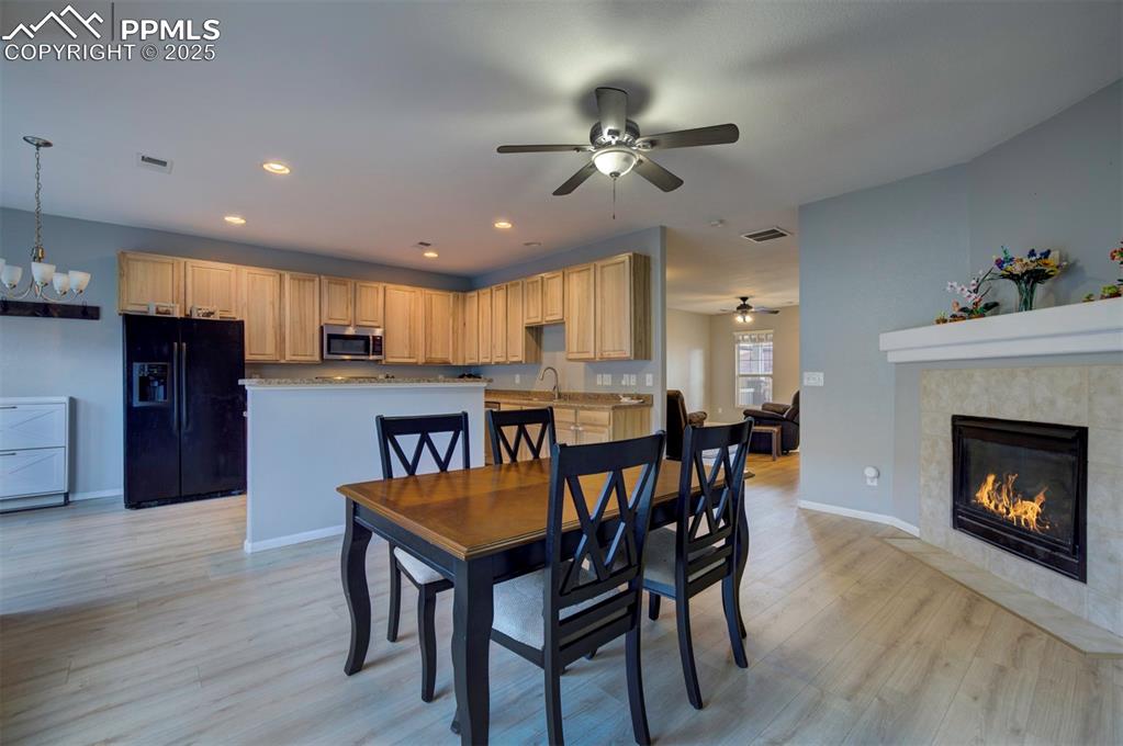 Image 12 of 43: Dining room featuring light wood-style flooring, recessed lighting, a tile 