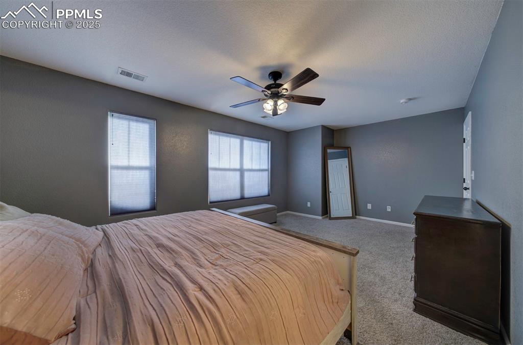 Image 31 of 43: Bedroom featuring carpet floors, ceiling fan, and a textured ceiling