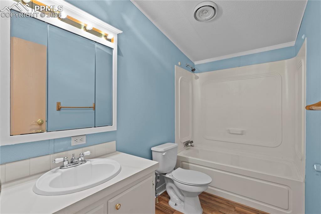 Image 19 of 29: Bathroom with shower / bathtub combination, vanity, and wood finished floor
