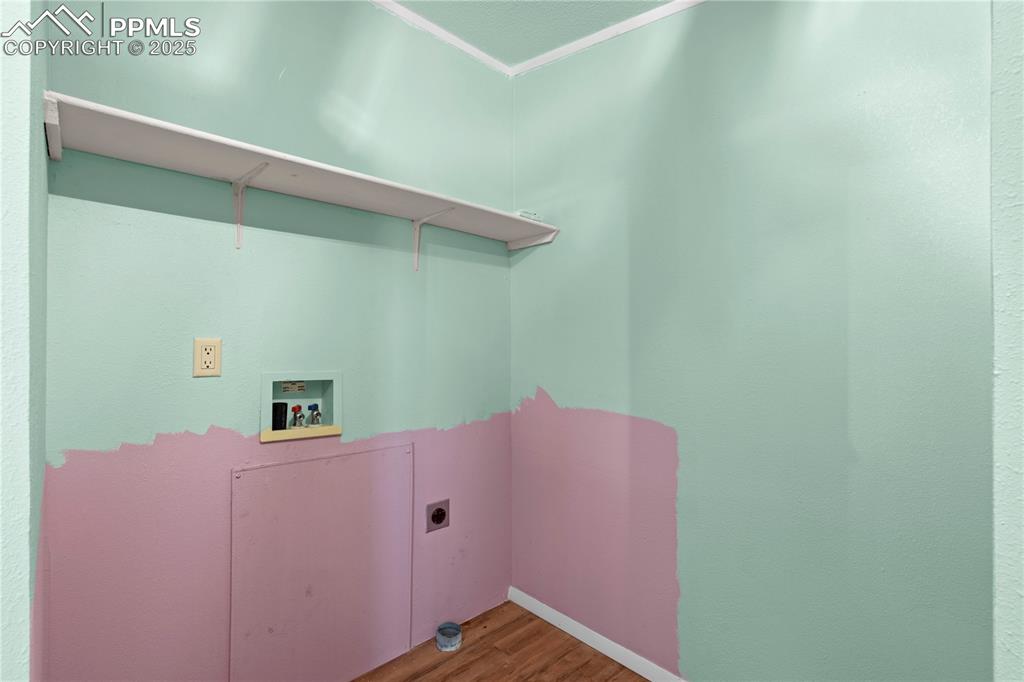 Image 22 of 29: Washroom featuring wood finished floors, hookup for a washing machine, and 